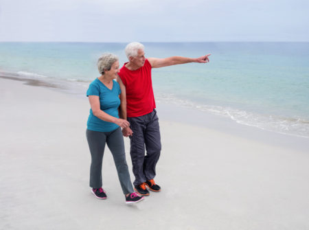 senior-walking-club-on-beach